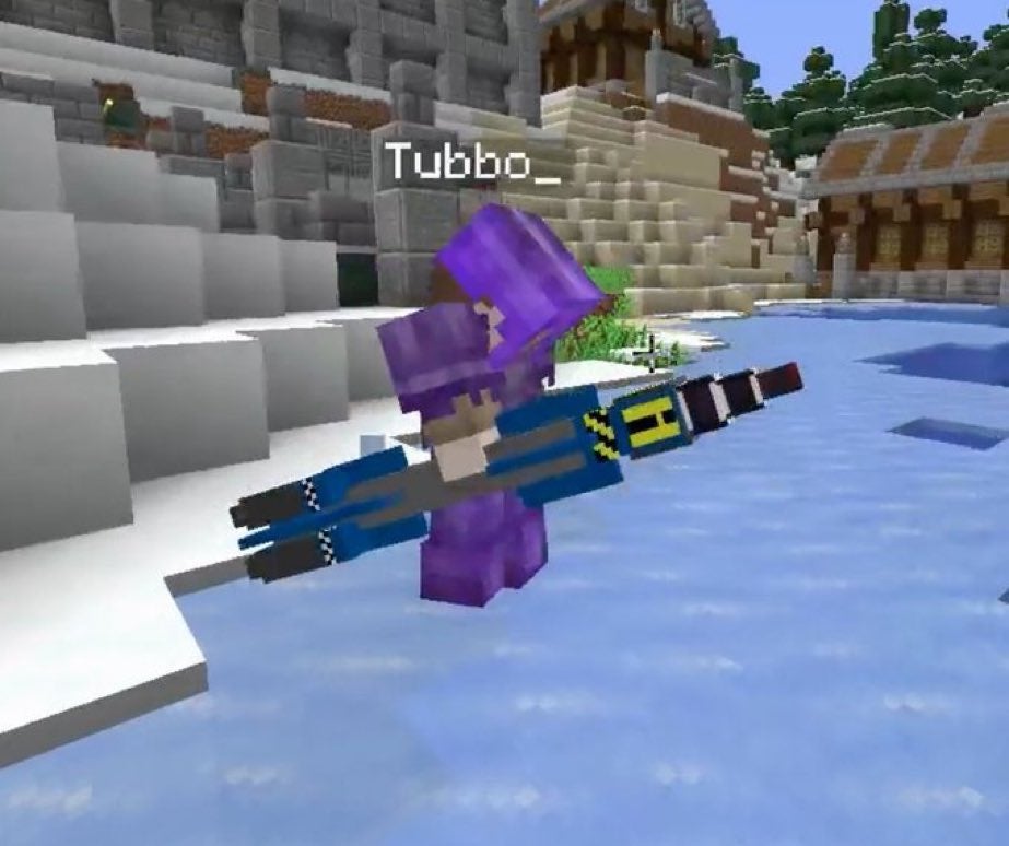 A screenshot from someone's stream. Tubbo stands on top of a frozen river in Snowchester, decked out in full netherite armor. He holds a long rocket-shaped nuke in his hand.
